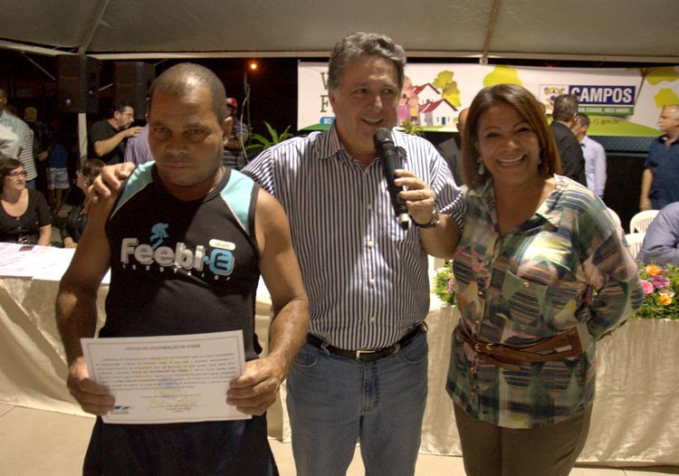 José Carlos Conceição da Silva, morador do Condomínio das Lagoas, recebeu o título de legitimação de posse, nesta segunda-feira, entregue pelo secretário de Governo, Antony Garotinho, junto com a coordenadora do Viver Feliz, Linda Mara Silva (Foto: Rodolfo Lins)